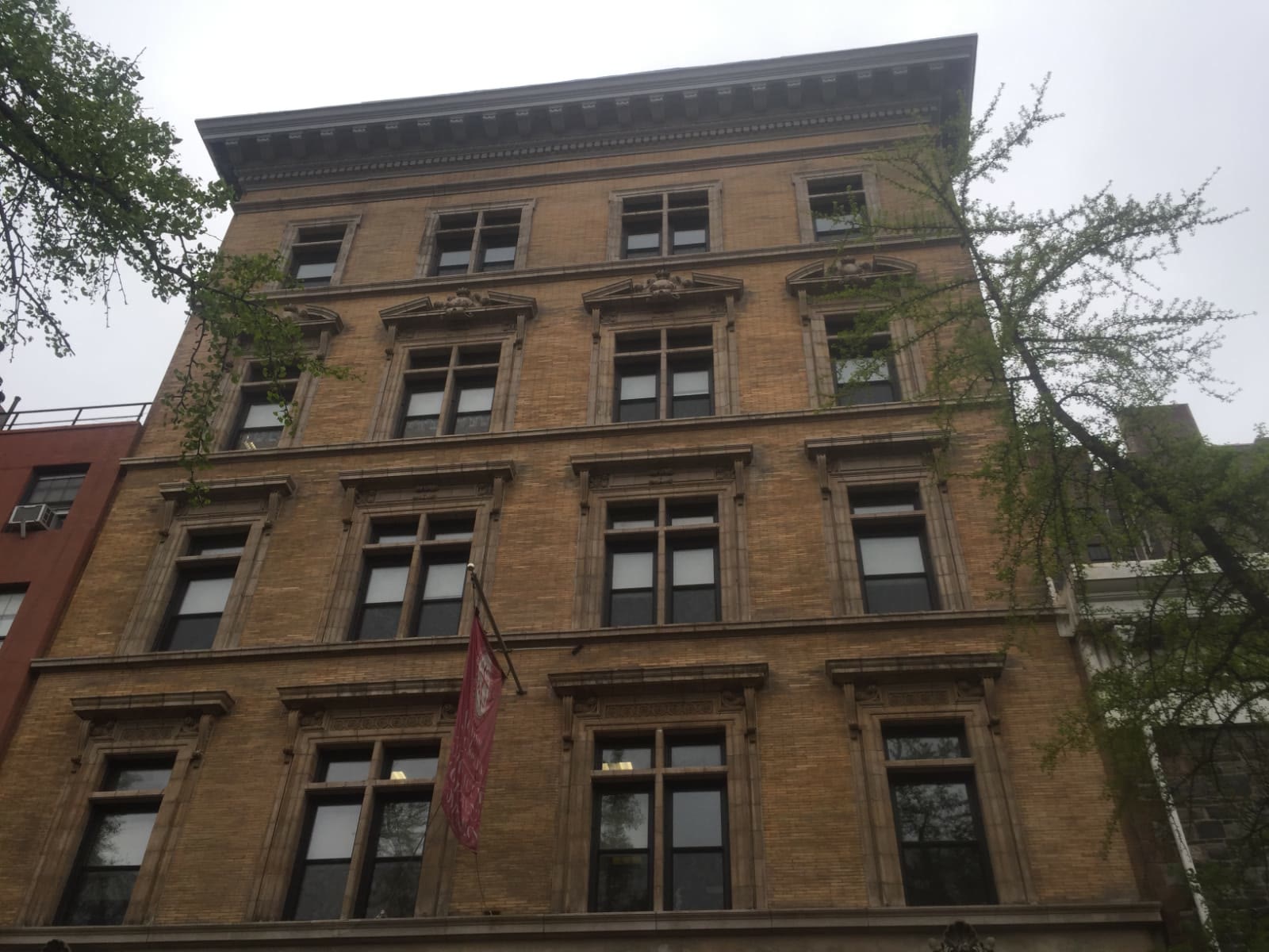 Historic stone row building facade in New York City with ornamental window surrounds