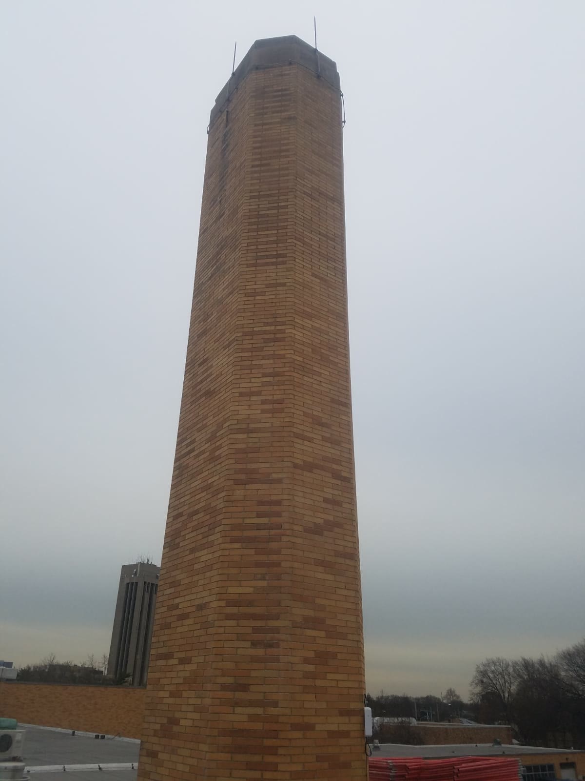 Restored freestanding brick smokestack at a school campus