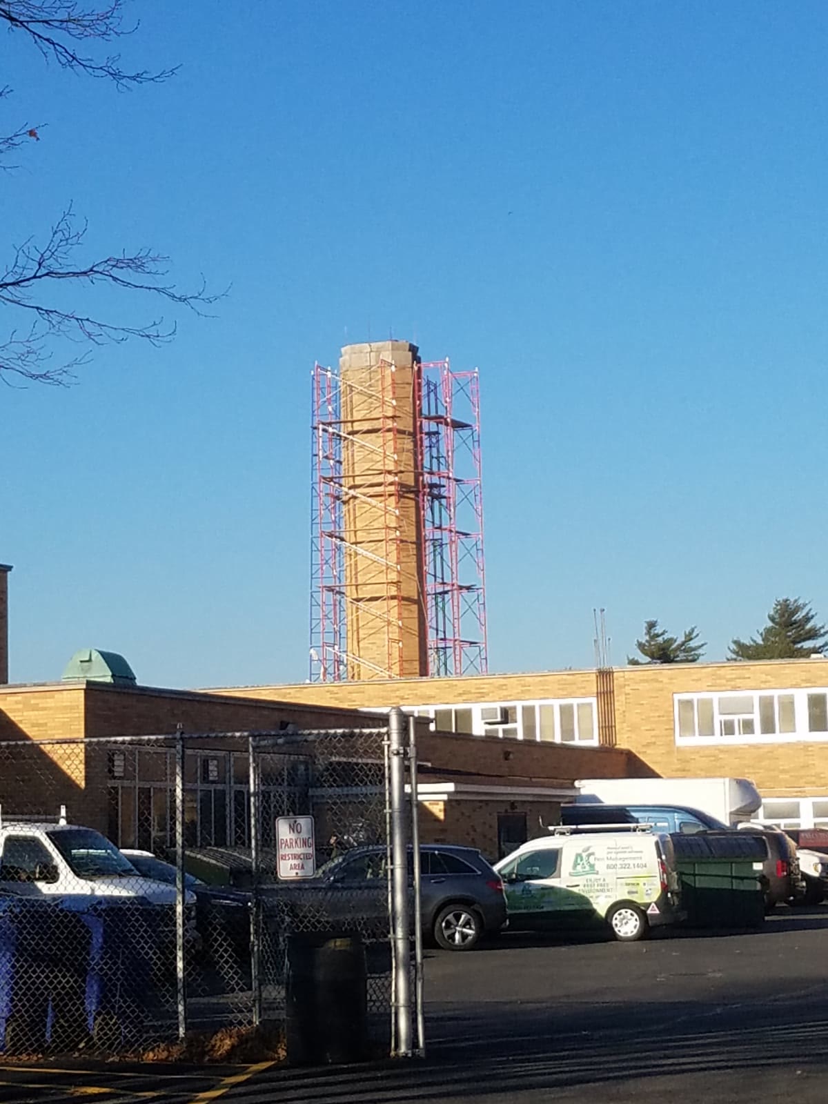Masonry chimney surrounded by scaffolding during repairs