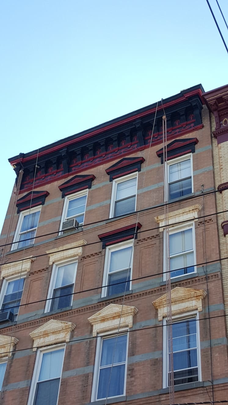 Prewar brick building with an ornate cornice in New York City