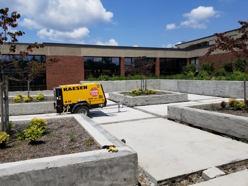 Cast-in-place concrete planter walls and new concrete paving in the Roslyn High School courtyard during construction